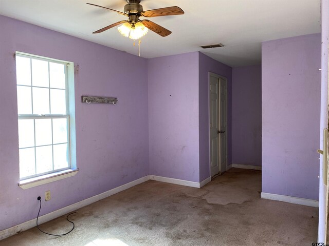 carpeted empty room with ceiling fan