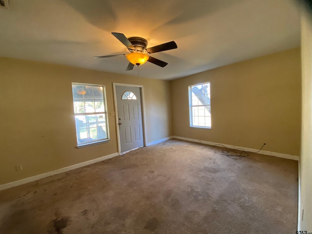 entryway featuring light carpet and ceiling fan