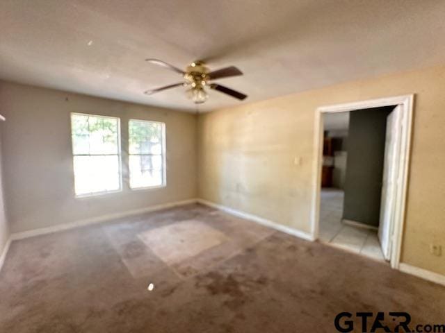 carpeted empty room with ceiling fan