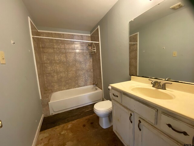 full bathroom with toilet, vanity, and tiled shower / bath