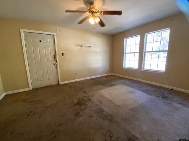 spare room with carpet floors and ceiling fan