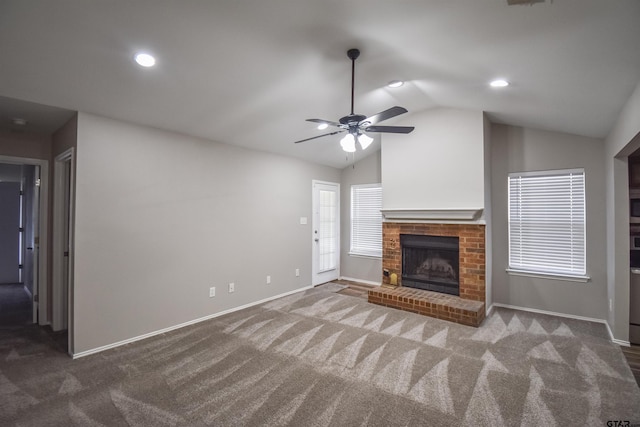 105 Ash Dr, Bullard, TX 75757 - unfurnished living room featuring vaulted ceiling, carpet flooring, a ceiling fan, a brick fireplace, and baseboards