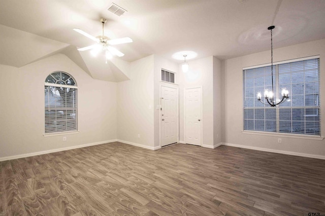 interior space featuring visible vents, ceiling fan with notable chandelier, dark wood-type flooring, and baseboards