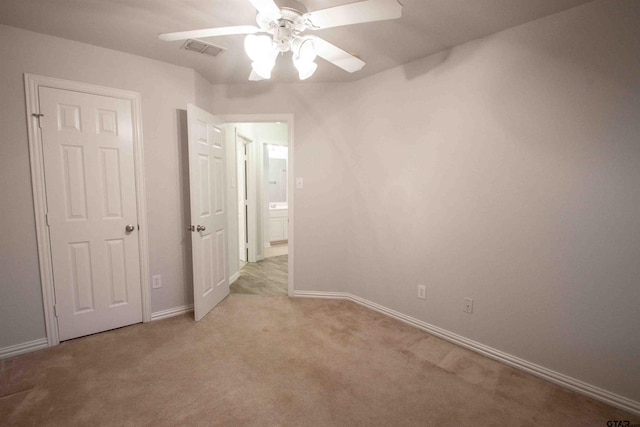 unfurnished bedroom featuring visible vents, carpet flooring, a ceiling fan, and baseboards