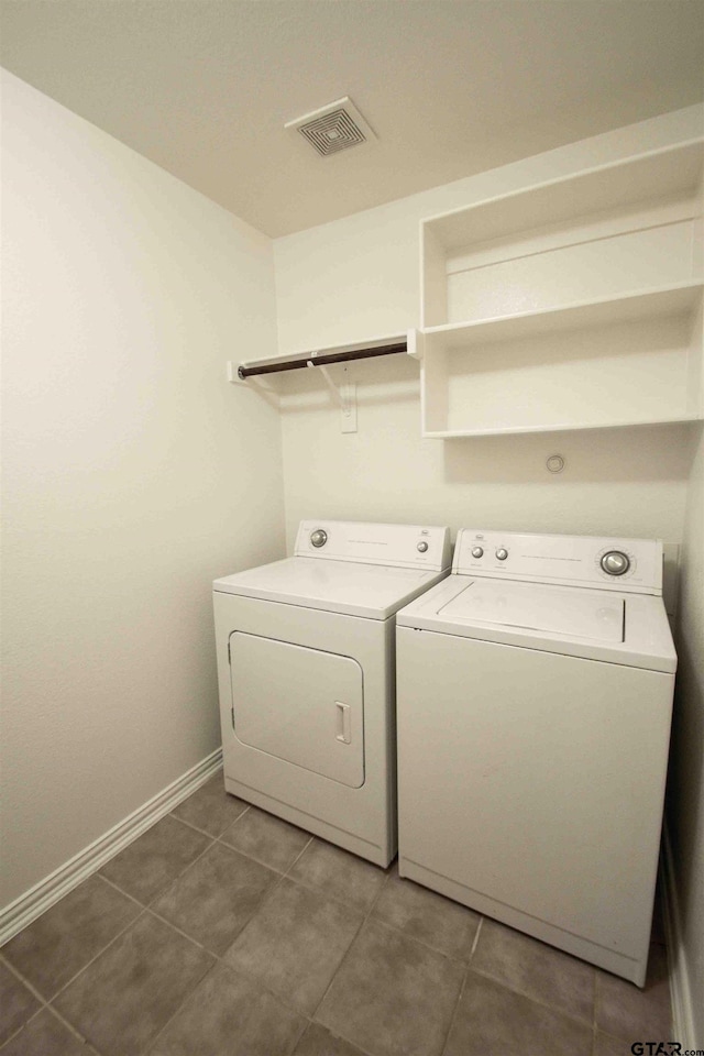 washroom featuring visible vents, baseboards, laundry area, separate washer and dryer, and tile patterned floors