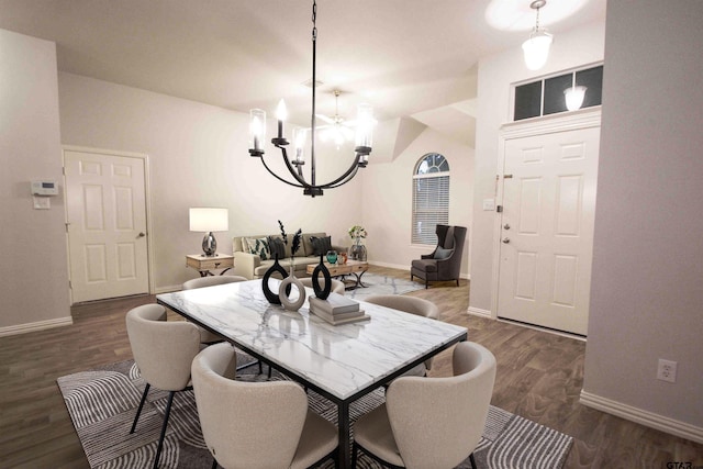 dining room featuring an inviting chandelier, dark wood-type flooring, and baseboards