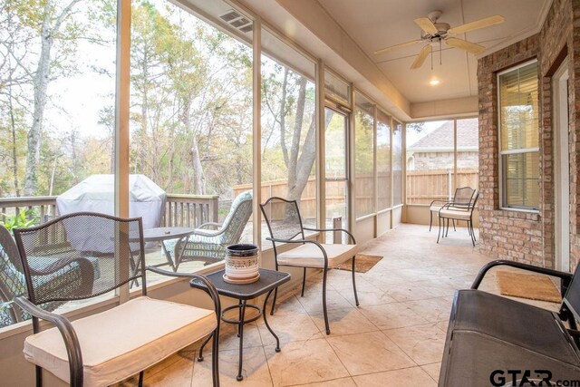 sunroom featuring ceiling fan