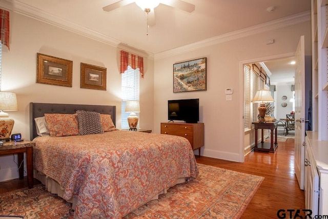 bedroom with ceiling fan, hardwood / wood-style floors, and ornamental molding