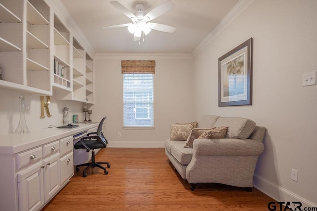 office with built in desk, light hardwood / wood-style floors, ceiling fan, and ornamental molding