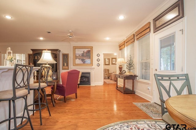 dining room with ceiling fan, light hardwood / wood-style floors, and ornamental molding