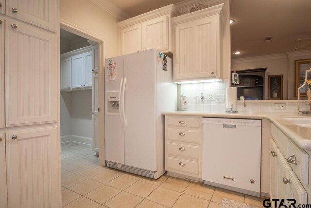 kitchen featuring decorative backsplash, light tile patterned flooring, white appliances, and ornamental molding