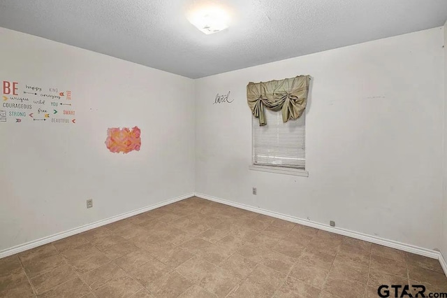 empty room featuring a textured ceiling