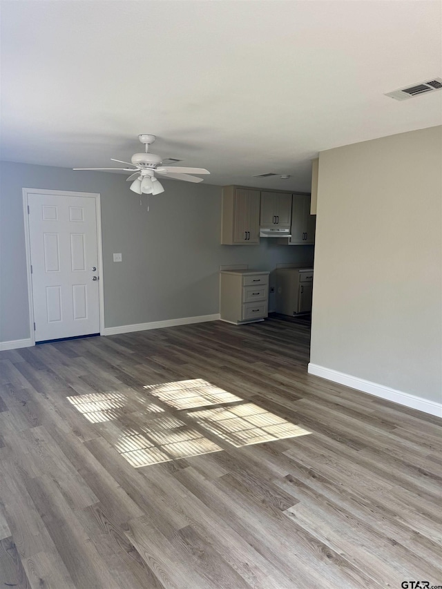 unfurnished living room featuring ceiling fan and light hardwood / wood-style floors