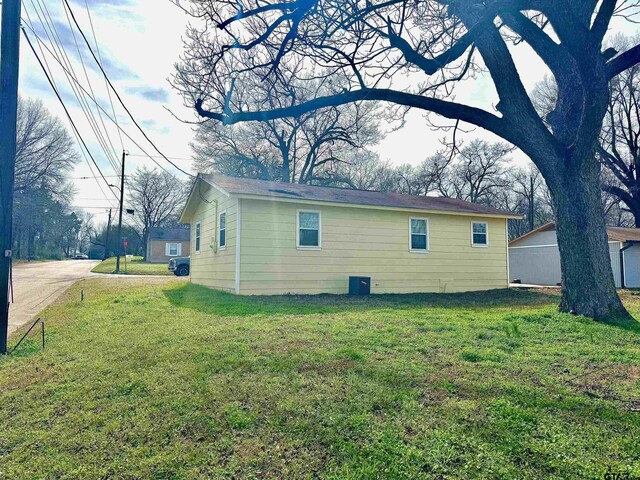 view of side of home featuring a lawn