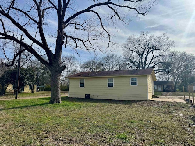 view of side of home featuring a lawn