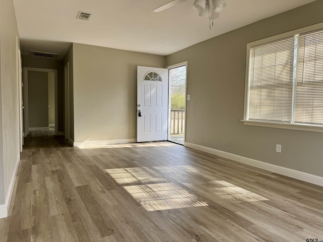 foyer with ceiling fan and light wood-type flooring