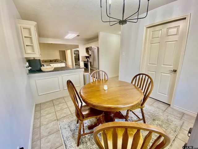 403 Aspen Bend St, Crockett, TX 75835 - dining area with light tile patterned flooring and a chandelier