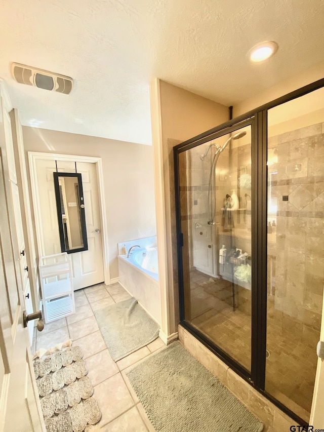 403 Aspen Bend St, Crockett, TX 75835 - bathroom featuring a garden tub, a stall shower, tile patterned flooring, and a textured ceiling
