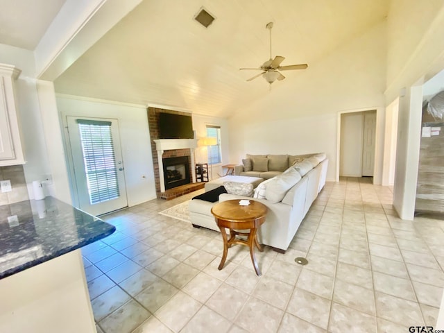403 Aspen Bend St, Crockett, TX 75835 - living room featuring light tile patterned floors, ceiling fan, a brick fireplace, and lofted ceiling
