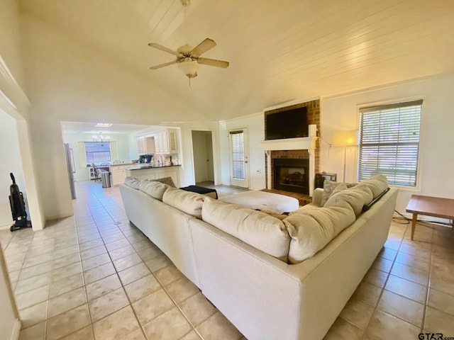 403 Aspen Bend St, Crockett, TX 75835 - living room with light tile patterned floors, a ceiling fan, a fireplace, and high vaulted ceiling