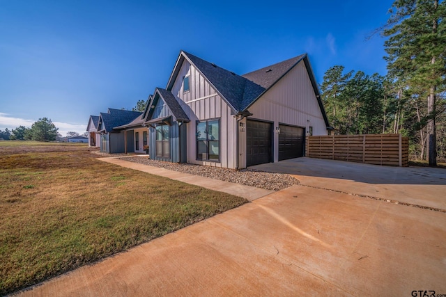 view of side of home featuring a lawn and a garage