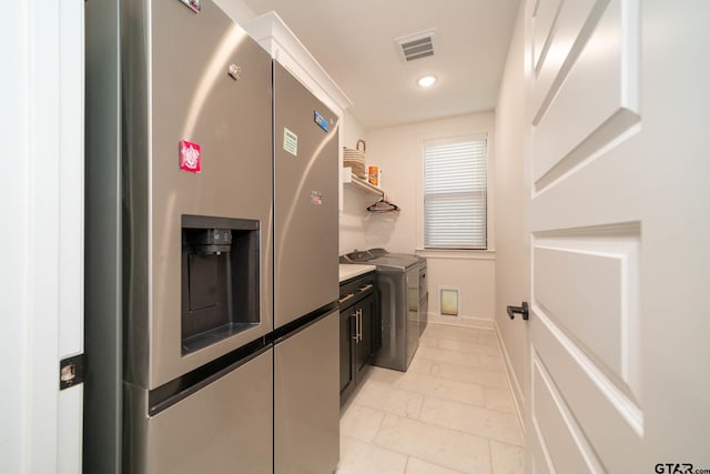 washroom featuring washer and dryer and light tile patterned floors