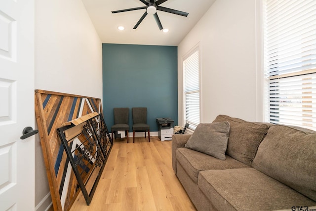 living room featuring ceiling fan, a healthy amount of sunlight, and light hardwood / wood-style flooring