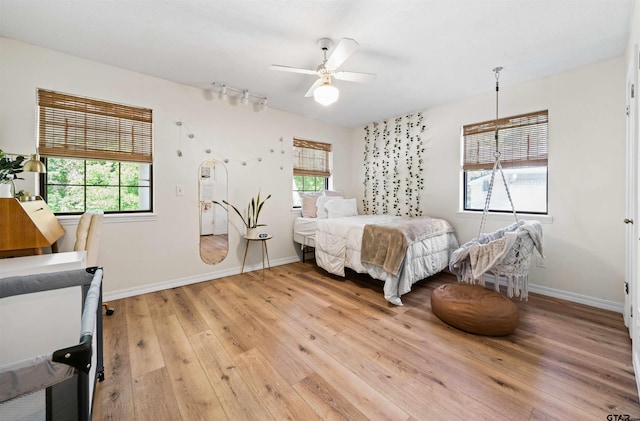 bedroom with light hardwood / wood-style flooring and ceiling fan