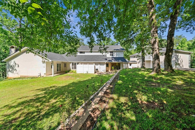 rear view of property with a yard