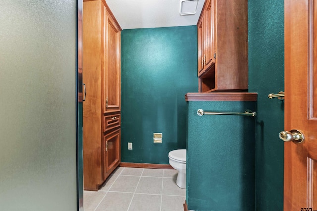 bathroom with tile patterned flooring and toilet