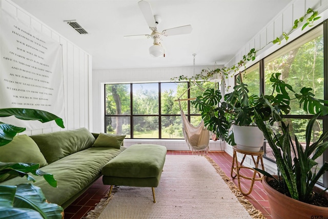 sunroom featuring ceiling fan