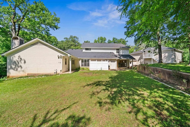 rear view of property featuring a lawn