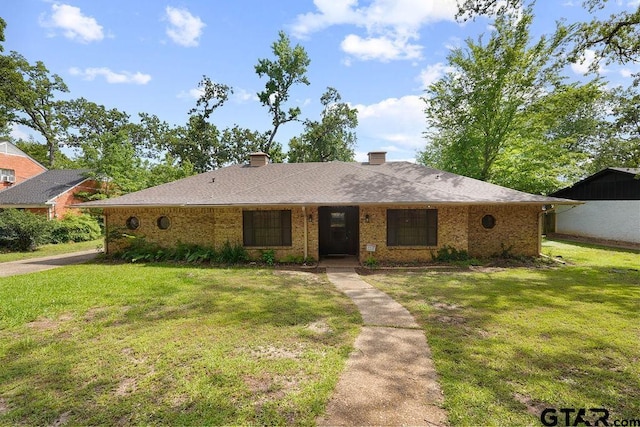 single story home featuring a front lawn, brick siding, and a chimney