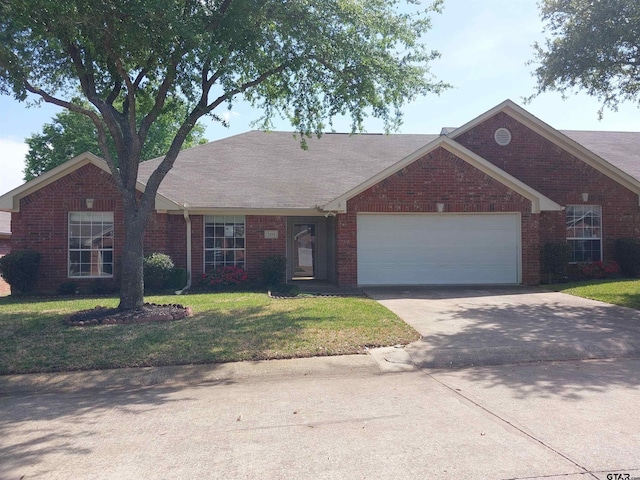 ranch-style house with a garage and a front lawn