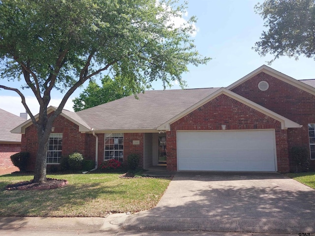 single story home featuring a garage and a front yard