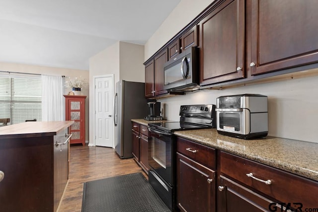 kitchen featuring dark brown cabinets, appliances with stainless steel finishes, and dark wood-type flooring