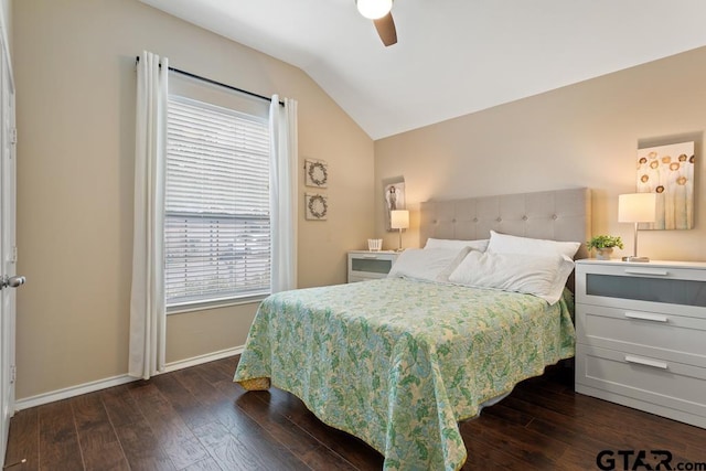 bedroom featuring dark hardwood / wood-style flooring, multiple windows, vaulted ceiling, and ceiling fan