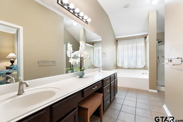 bathroom featuring tile patterned flooring, shower with separate bathtub, lofted ceiling, and vanity