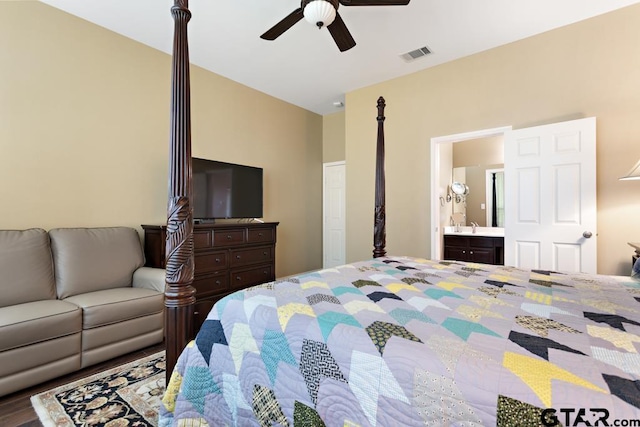 bedroom with ensuite bathroom, wood-type flooring, and ceiling fan