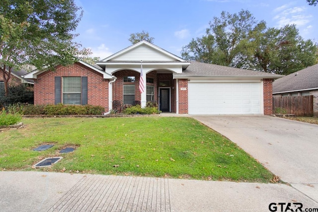 view of front of house with a garage and a front lawn