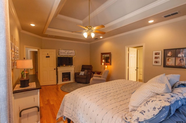 8416 Crooked Trl, Tyler, TX 75703 - bedroom featuring wood finished floors, ornamental molding, a fireplace, and recessed lighting