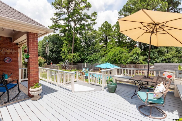 8416 Crooked Trl, Tyler, TX 75703 - wooden terrace featuring a fenced backyard, outdoor dining space, and view of scattered trees