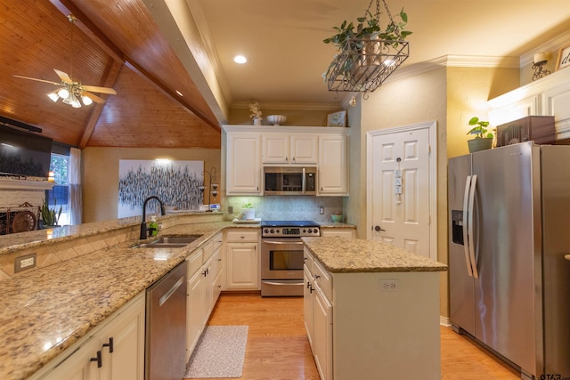8416 Crooked Trl, Tyler, TX 75703 - kitchen with stainless steel appliances, light wood-style floors, white cabinetry, tasteful backsplash, and light stone counters