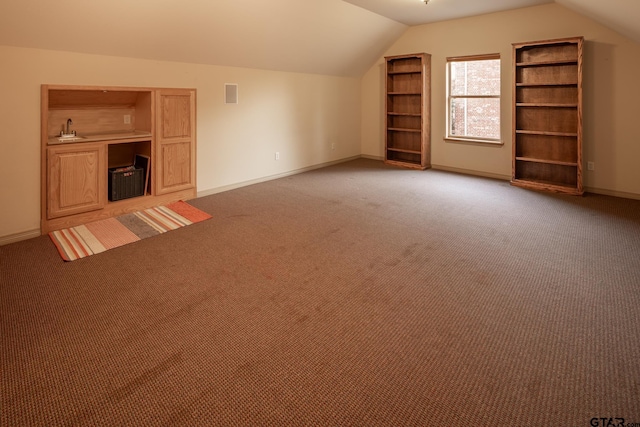 bonus room featuring sink, lofted ceiling, and carpet floors