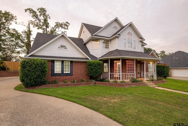 view of front of house featuring a porch and a lawn