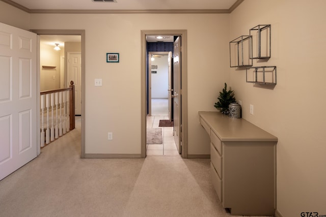 hall featuring light colored carpet and crown molding