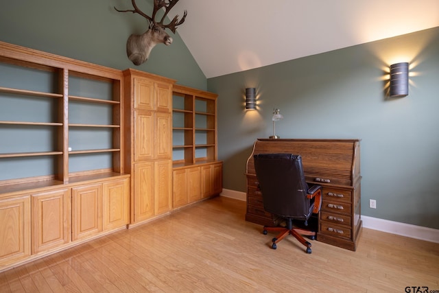 office space featuring vaulted ceiling and light hardwood / wood-style floors