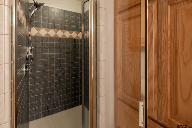 bathroom with a tile shower