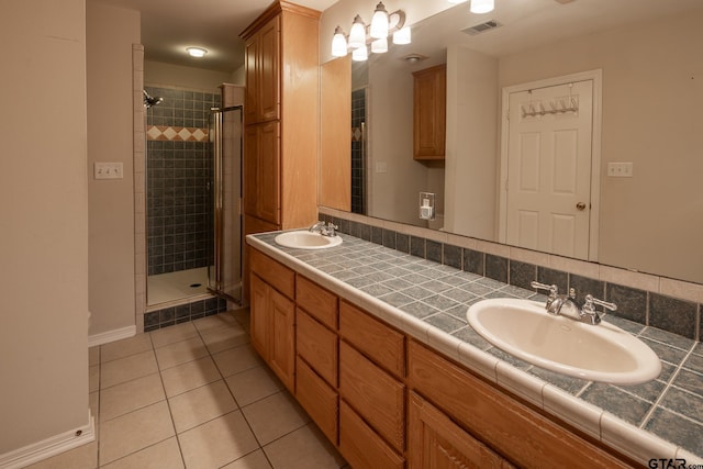 bathroom featuring tile patterned floors, walk in shower, and vanity