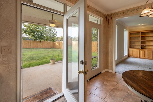 doorway to outside featuring french doors, light tile patterned floors, and crown molding